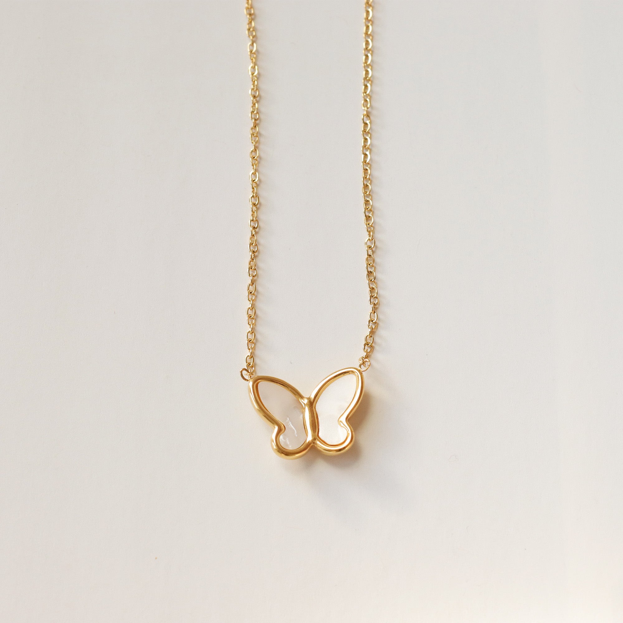 Simple gold butterfly on sale necklace